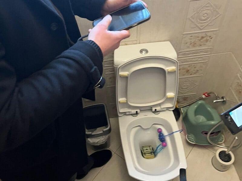 The GDB detained a regional council deputy and the deputy mayor, releasing a photo of dollars in a toilet.